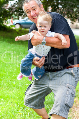 Fortunately Grandpa holding infant in arms