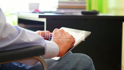 Office worker in wheelchair with tablet computer