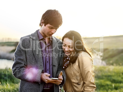 Happy young couple in the spring park. Family outdoors