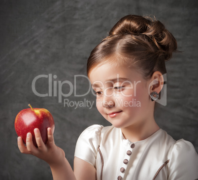 little girl holds apple