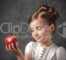 little girl holds apple