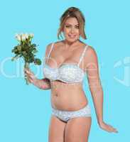 woman in lingerie carrying flowers