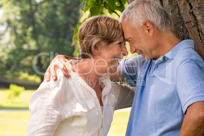 Elderly couple laughing head to head