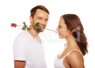 husband offering a rose to his happy wife