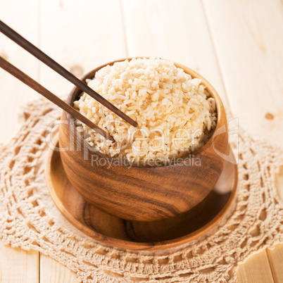 Eating rice with chopsticks.