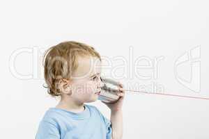 young child with tin can phone