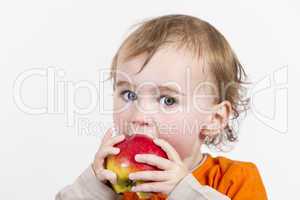 young child eating red apple
