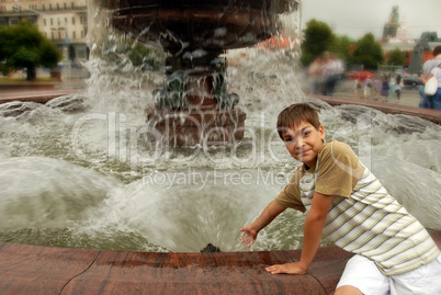 Smiling boy by fountain