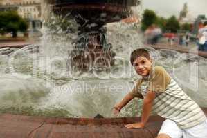 Smiling boy by fountain