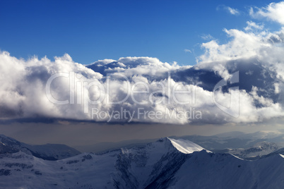 winter mountains in evening and sunlight clouds
