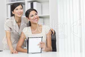 Asian Chinese & Hispanic Businesswomen Using Tablet Computer