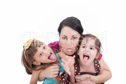 Mother and two daughter pulling funny faces at camera