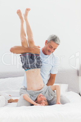 Father holding his son upside down