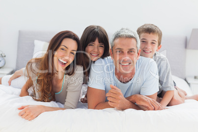 Happy family lying together Happy family lying together
