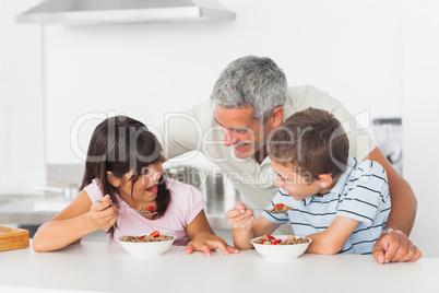 Father talking with his children during their breakfast