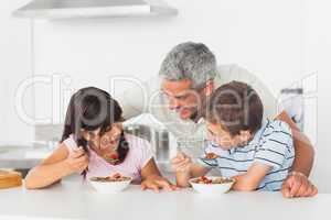 Father talking with his children during their breakfast