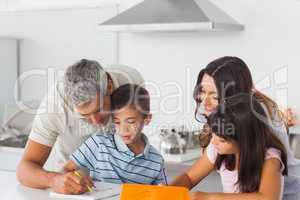 Family drawing together in kitchen
