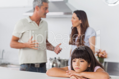 Couple having dispute in front of their unhappy daughter