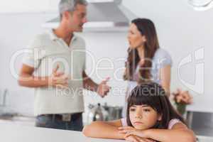 Couple having dispute in front of their unhappy daughter