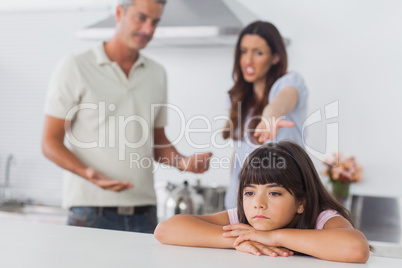 Couple having dispute in front of their upset daughter