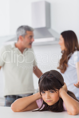 Angry couple having dispute in front of their daughter blocking