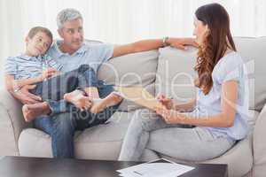 Parents with their son sitting on sofa