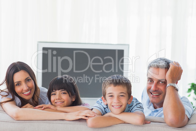 Family in sitting room smiling at camera