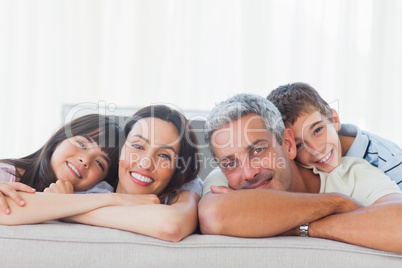 Beautiful family in sitting room smiling at camera