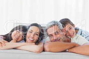 Beautiful family in sitting room smiling at camera