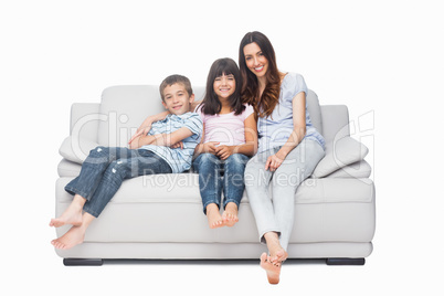 Mother with their children sitting on sofa