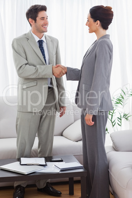 Colleagues having handshake during meeting