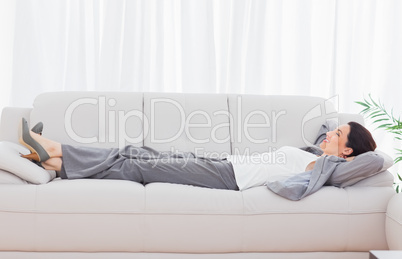 Businesswoman lying on sofa relaxing