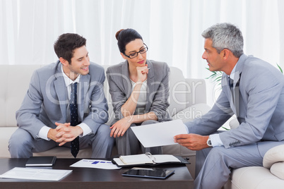 Business people working and talking together on sofa