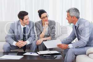 Business people working and talking together on sofa