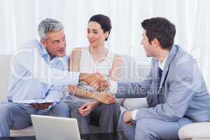 Salesman closing a deal with a smiling couple