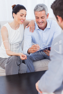 Couple signing salesman contract