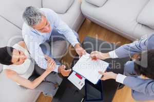 Salesman showing contract to couple