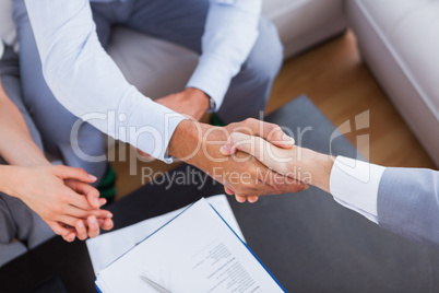 Salesman shaking hands with client
