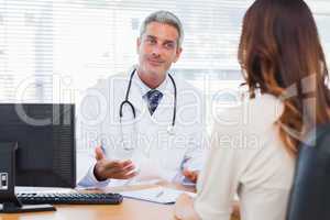 Smiling doctor talking with his patient