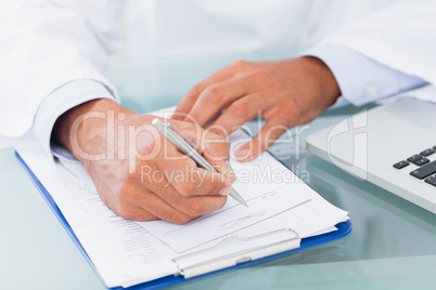 Hand of a doctor writing on a prescription