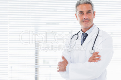 Smiling doctor crossing his arms