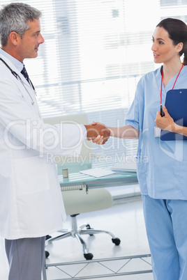 Doctor shaking hands with nurse