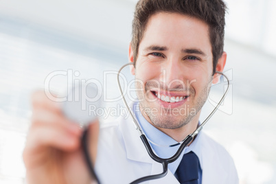 Smiling doctor with his stethoscope looking at camera