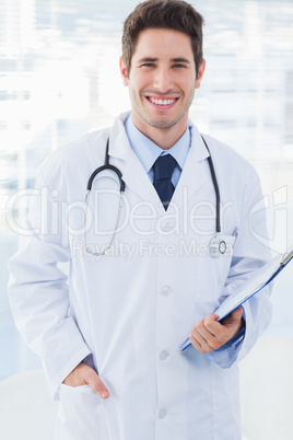 Doctor holding files and smiling at camera