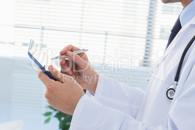 Doctor using his tablet pc