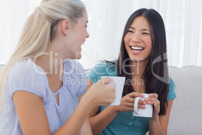 Young friends catching up over cups of coffee