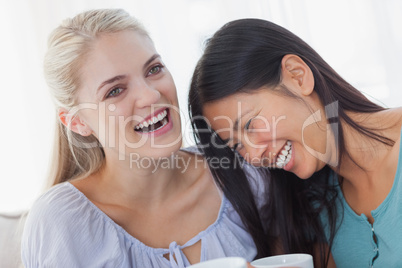 Friends drinking coffee together and laughing