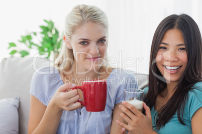 Blonde woman smiling at camera with friend