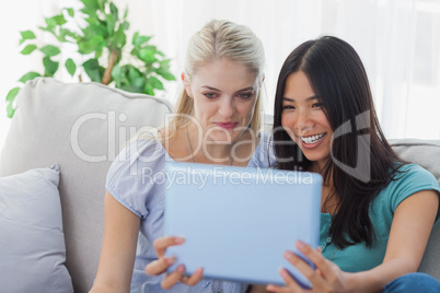 Two friends taking photo with tablet pc