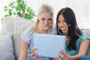Two friends taking photo with tablet pc